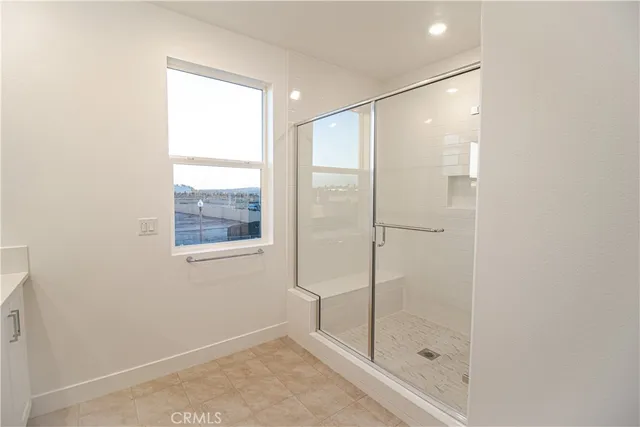 a bathroom with a shower and a window