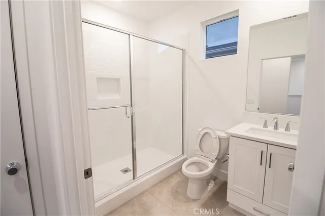 a bathroom with a toilet a sink and shower