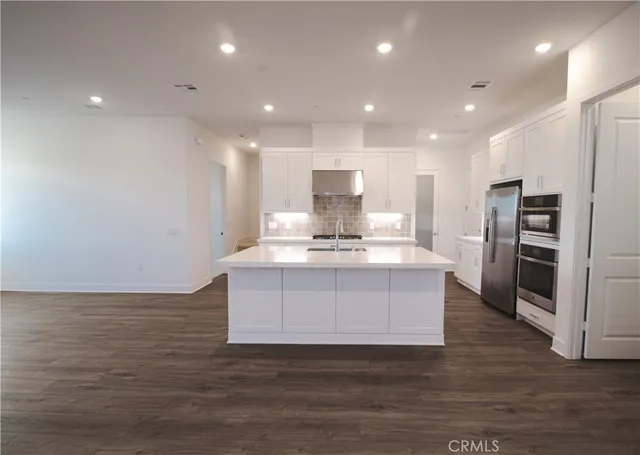 a view of kitchen cabinets and stainless steel appliances