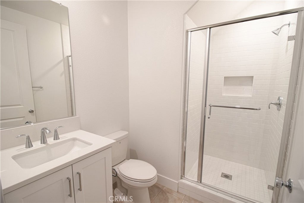 635 Gadwall Irvine, CA 92618 - Photo 7 of 27 a bathroom with a granite countertop sink toilet and shower
