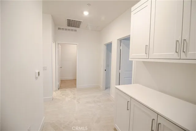 a view of a kitchen with white cabinets