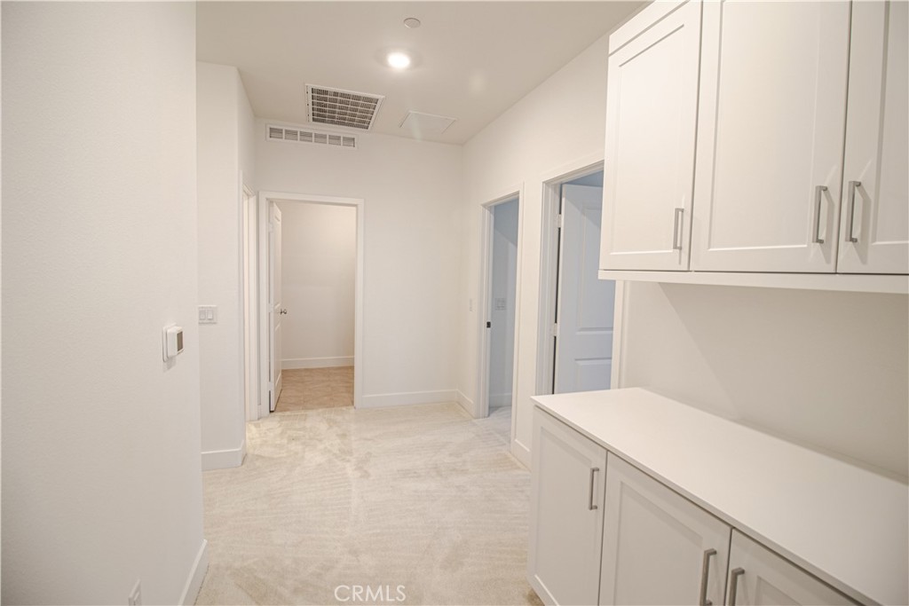 635 Gadwall Irvine, CA 92618 - Photo 9 of 27 a view of a kitchen with white cabinets