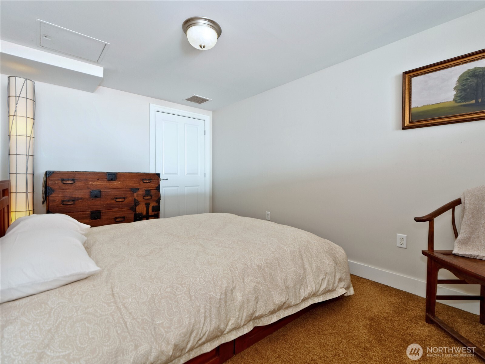 1500 4th Avenue, Unit 905 Seattle, WA 98101 - Photo 13 of 20 a bedroom with a bed and a dresser