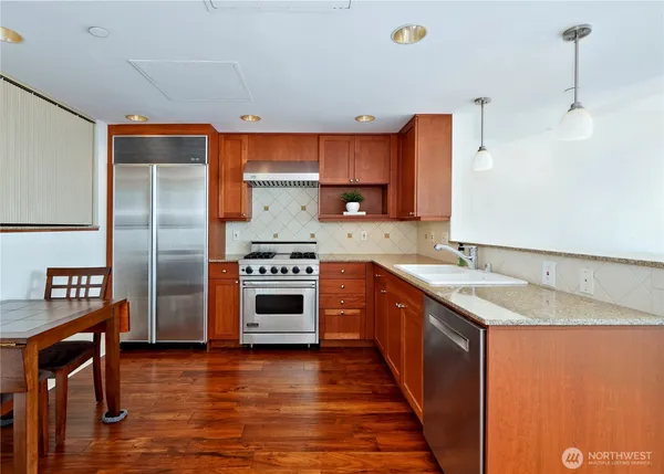 a kitchen with a table chairs and a refrigerator