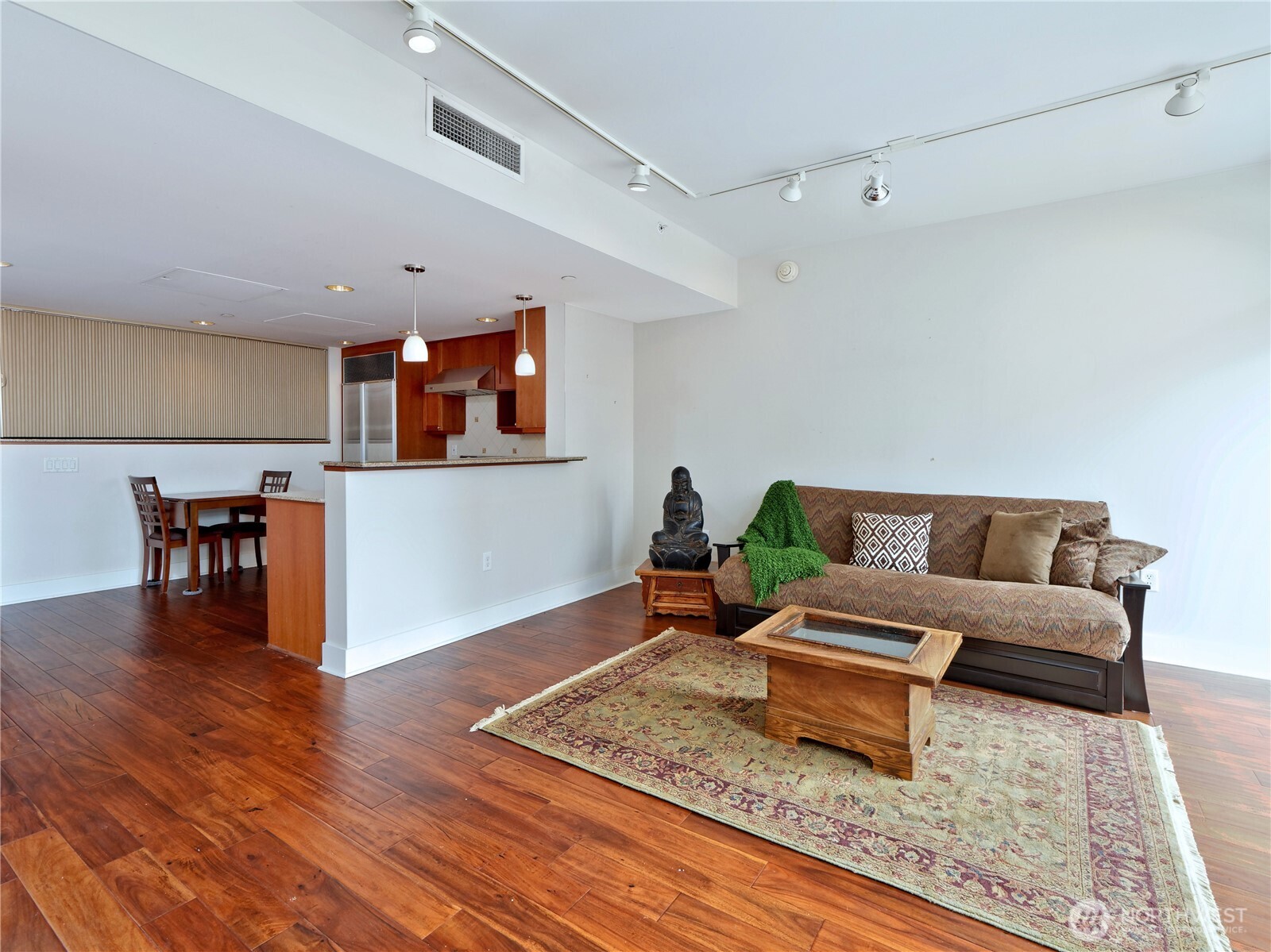 1500 4th Avenue, Unit 905 Seattle, WA 98101 - Photo 10 of 20 a living room with furniture and wooden floor