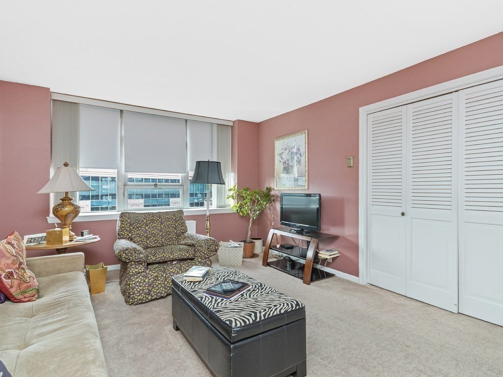 280 Boylston Street, Unit 415 Newton, MA 02467 - Photo 11 of 18 a living room with furniture and a large window
