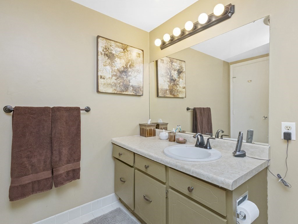 280 Boylston Street, Unit 415 Newton, MA 02467 - Photo 12 of 18 a bathroom with a sink vanity and a mirror