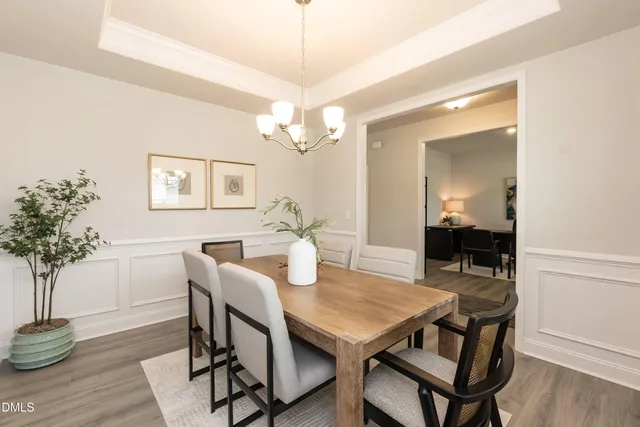 a kitchen with kitchen island a stove a table and chairs in it