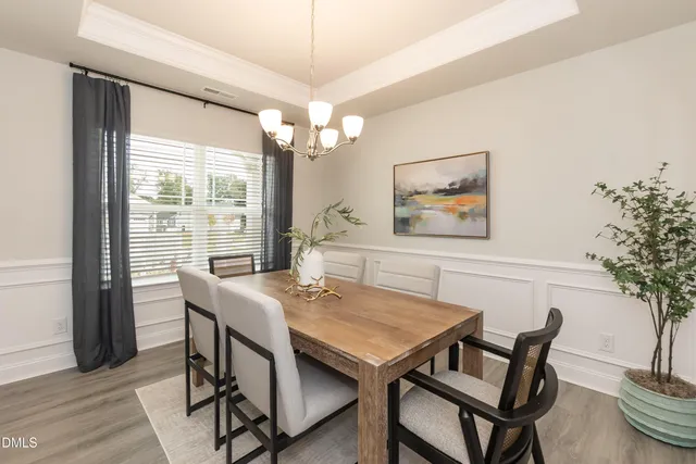 a kitchen with kitchen island a dining table and chairs