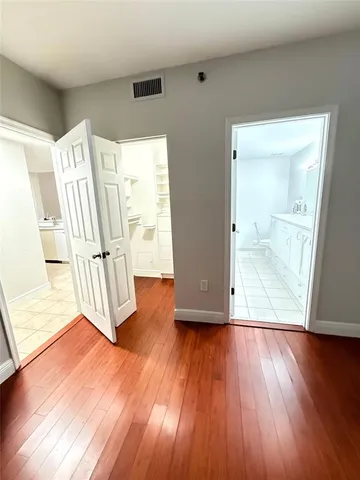 a en suite bathroom with a granite countertop sink and a mirror