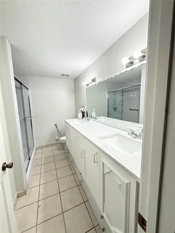 a bathroom with a glass shower door