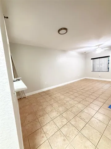 a view of an empty room and wooden floor