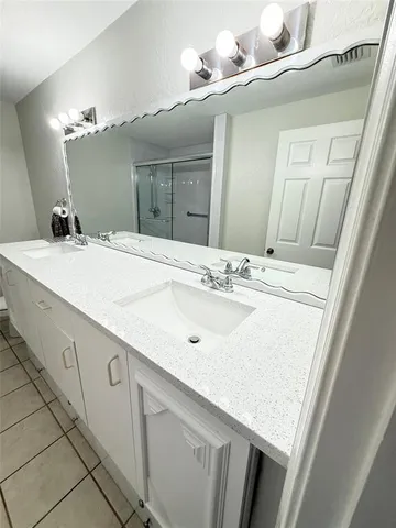 a view of a kitchen with a sink and a refrigerator