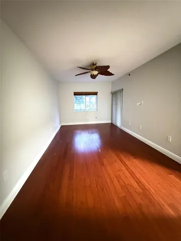 a bathroom with a granite countertop sink a toilet and a mirror