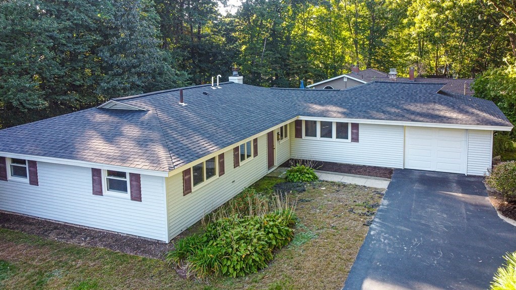a aerial view of a house next to a yard