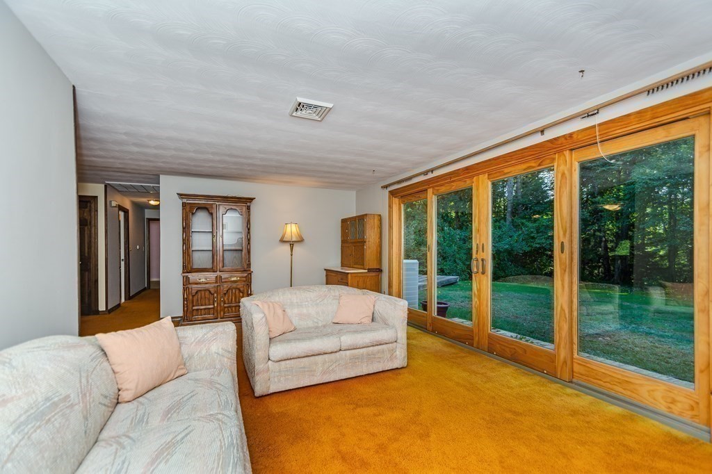 7 Ruthellen Road Chelmsford, MA 01824 - Photo 11 of 40 a bedroom with a large bed and a couch