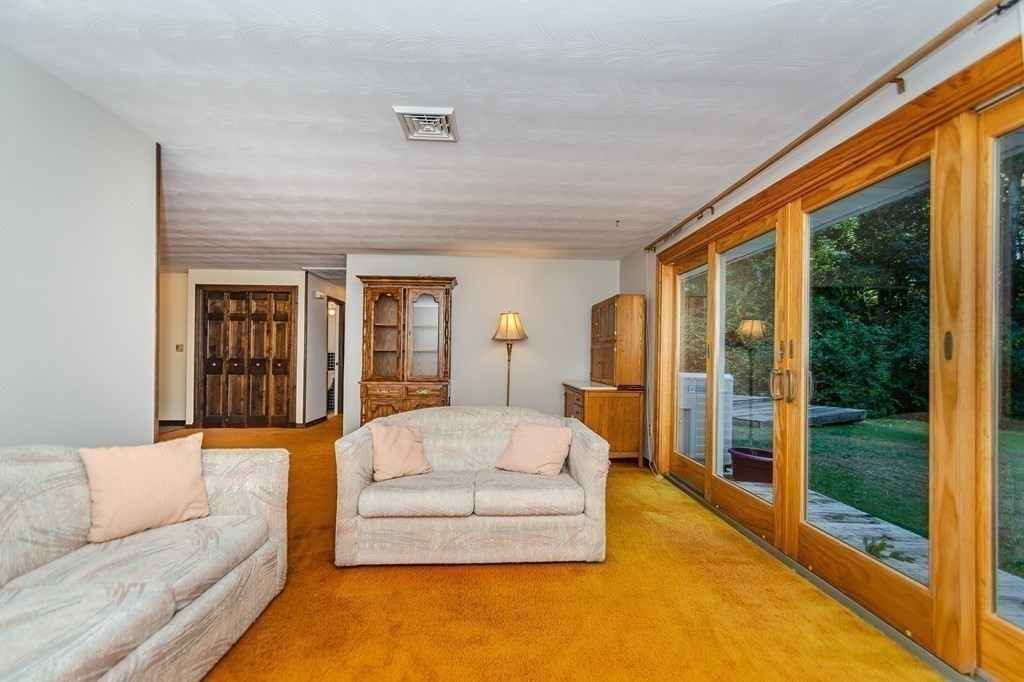 7 Ruthellen Road Chelmsford, MA 01824 - Photo 12 of 40 a living room with furniture and a large window