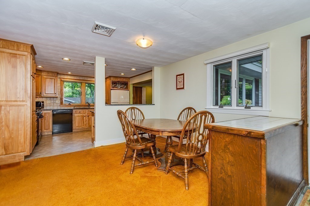 7 Ruthellen Road Chelmsford, MA 01824 - Photo 14 of 40 a dining room with furniture and a kitchen view