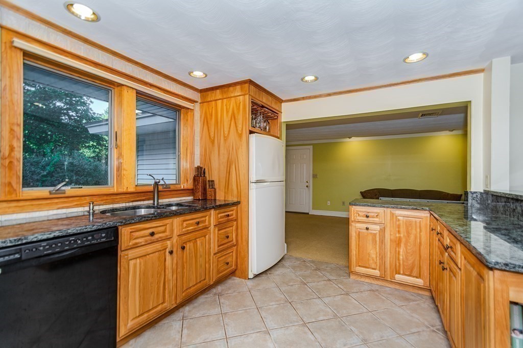 7 Ruthellen Road Chelmsford, MA 01824 - Photo 21 of 40 a kitchen with stainless steel appliances granite countertop a sink stove and refrigerator