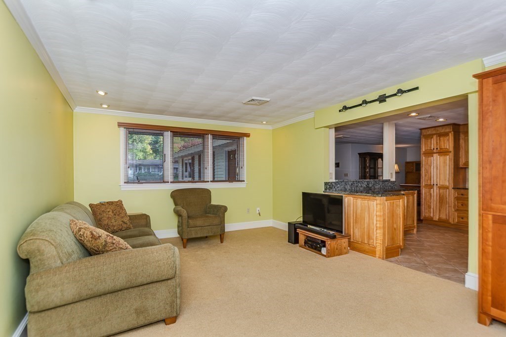 7 Ruthellen Road Chelmsford, MA 01824 - Photo 22 of 40 a living room with furniture and a flat screen tv