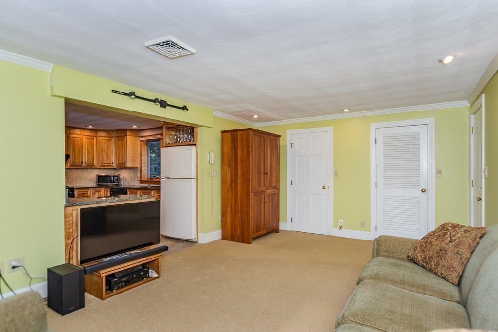 7 Ruthellen Road Chelmsford, MA 01824 - Photo 23 of 40 a living room with a couch and a refrigerator