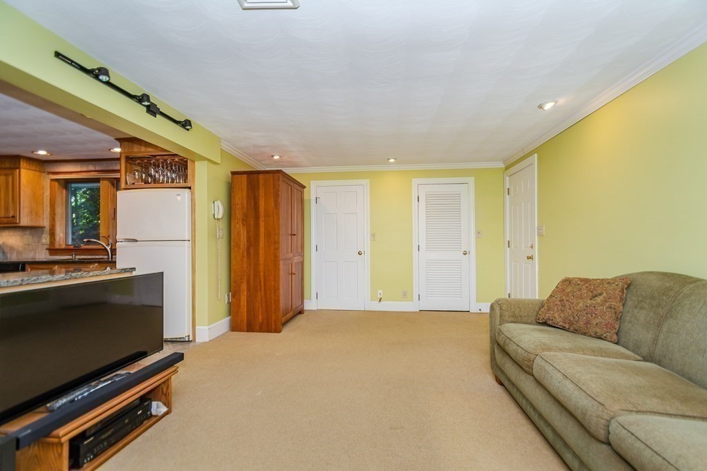 7 Ruthellen Road Chelmsford, MA 01824 - Photo 24 of 40 a living room with furniture and a flat screen tv