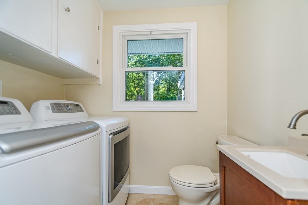 7 Ruthellen Road Chelmsford, MA 01824 - Photo 26 of 40 a bathroom with a granite countertop toilet sink and mirror