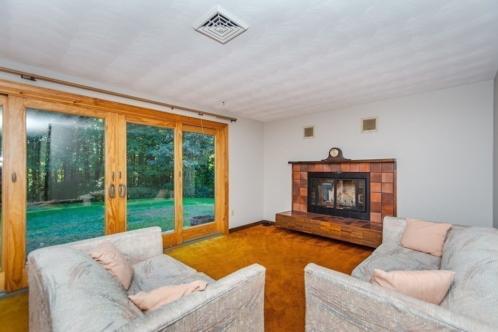 7 Ruthellen Road Chelmsford, MA 01824 - Photo 8 of 40 a living room with furniture and a fireplace