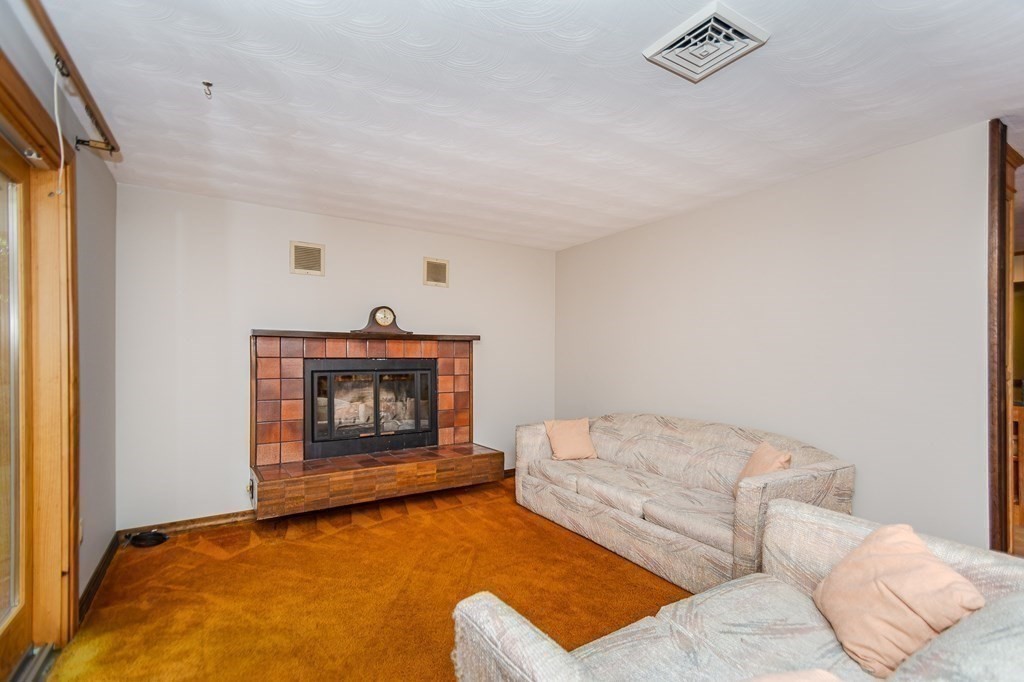 7 Ruthellen Road Chelmsford, MA 01824 - Photo 9 of 40 a living room with furniture and a fireplace