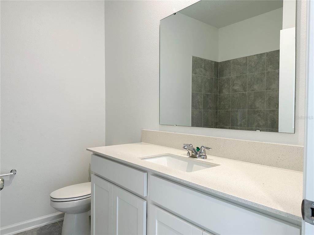 700 Daring Drive Davenport, FL 33837 - Photo 11 of 22 a bathroom with a sink toilet and a mirror