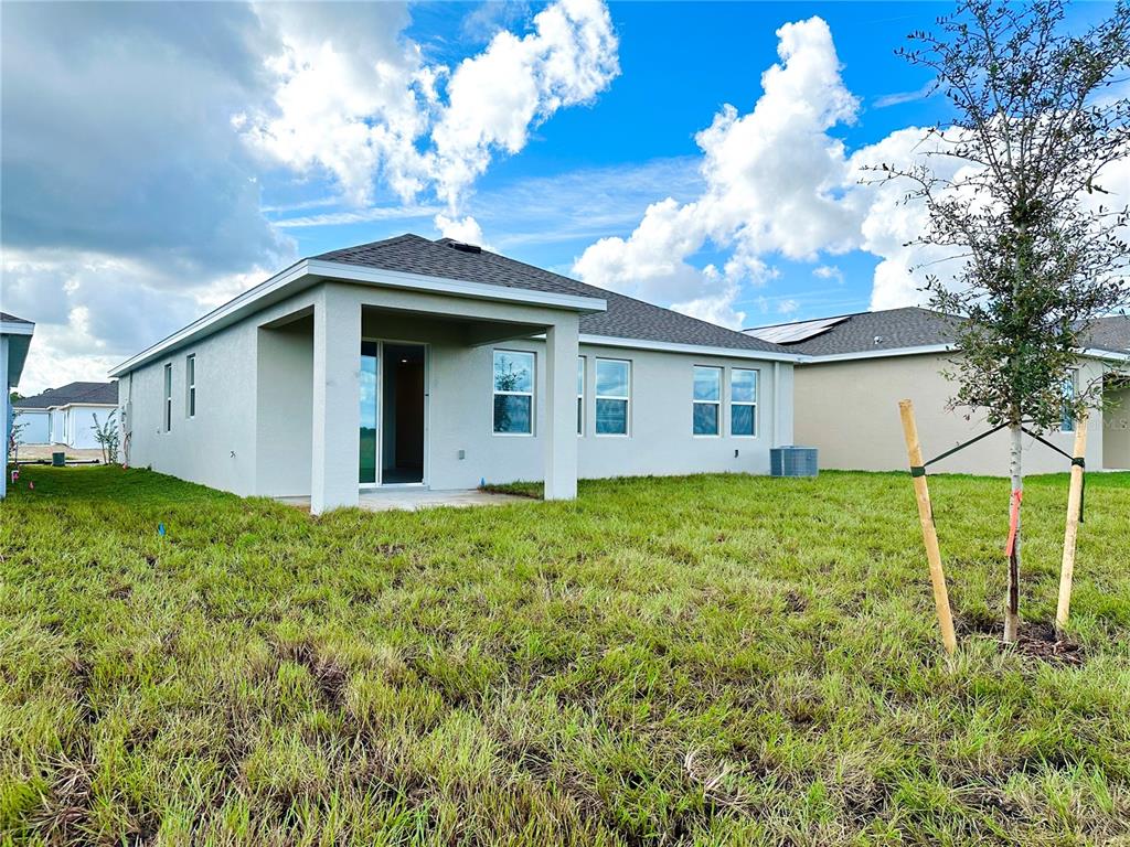 700 Daring Drive Davenport, FL 33837 - Photo 14 of 22 a view of a house with yard and a garden