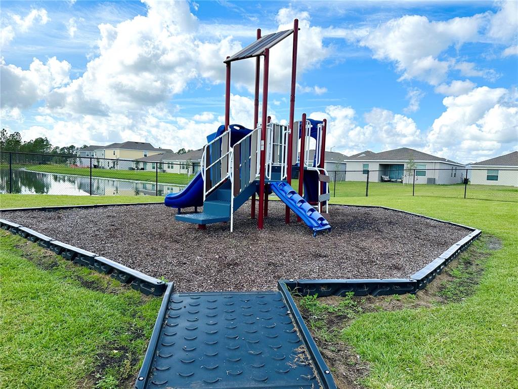 700 Daring Drive Davenport, FL 33837 - Photo 19 of 22 a view of outdoor space with playground