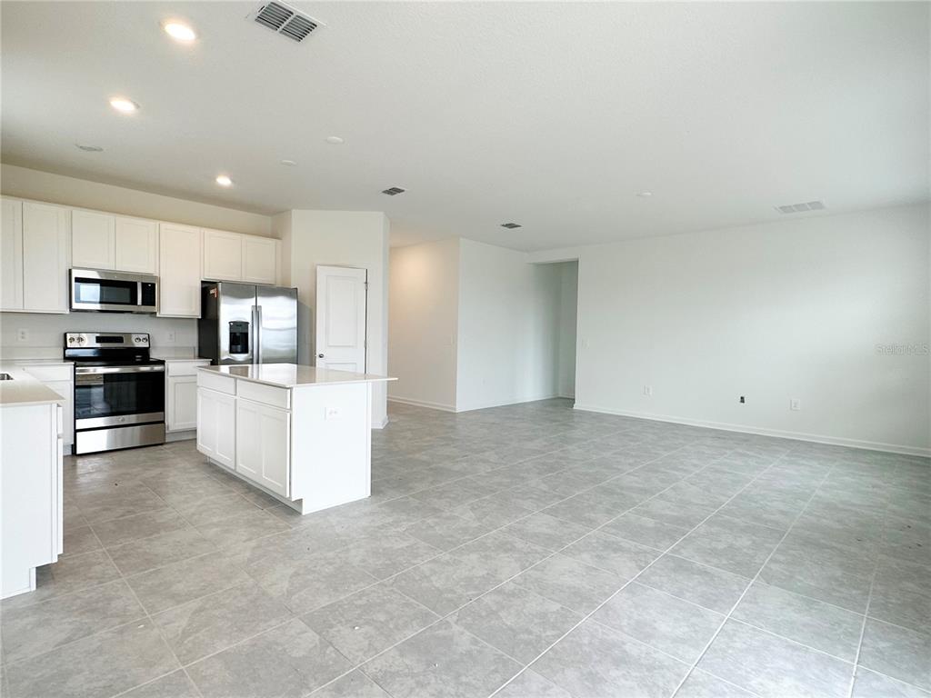 700 Daring Drive Davenport, FL 33837 - Photo 5 of 22 a view of kitchen with microwave and cabinets