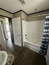 a bathroom with a bathtub and shower