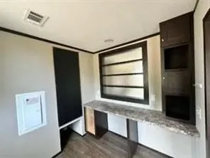 a room with window and flat screen tv