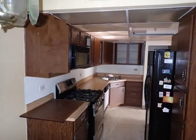 a kitchen with stainless steel appliances granite countertop a stove and a refrigerator