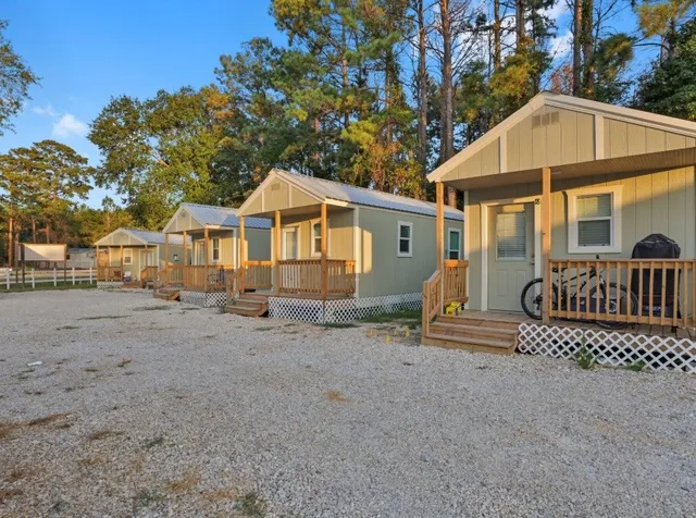 a view of a house with a yard and tree s