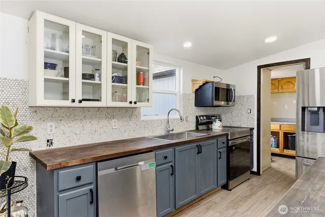 a kitchen with a sink and a stove top oven
