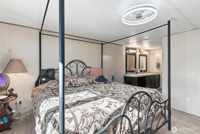 a bedroom with a bed and a mirror