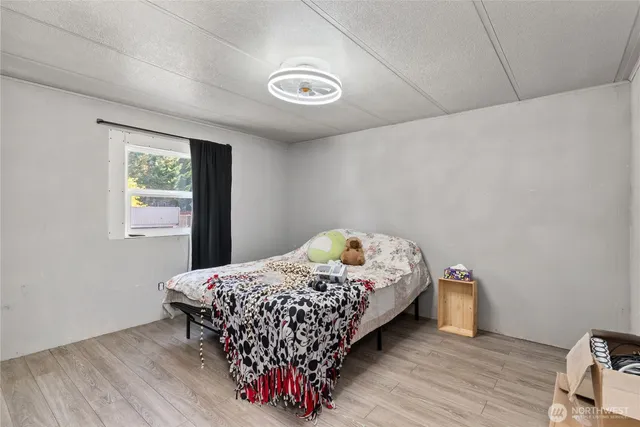 a bedroom with a bed and a window