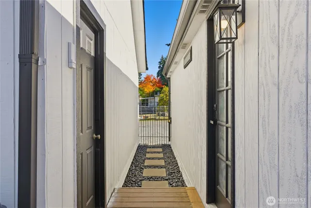 a view of a hallway with wooden floor and stairs