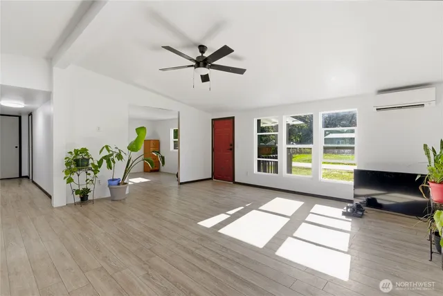 a view of workspace with wooden floor and a window
