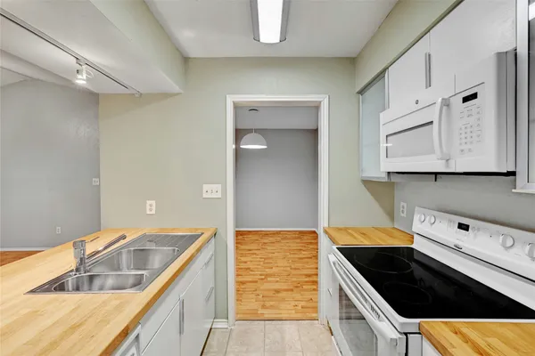 a kitchen with stainless steel appliances granite countertop a sink and cabinets