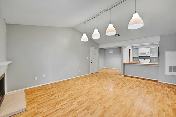 a view of a kitchen with a stove cabinets and a wooden floor