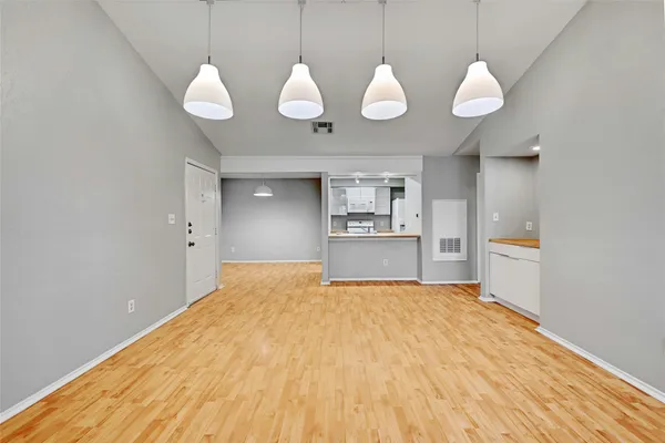 a view of a kitchen with wooden floor and a sink