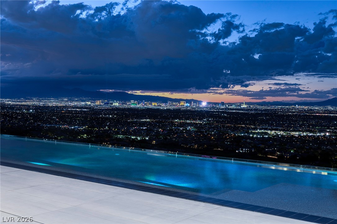 611 Cityview Ridge Drive Henderson, NV 89012 - Photo 3 of 66 Glittering city lights provide a spectacular backdrop to the sleek infinity-edge pool.