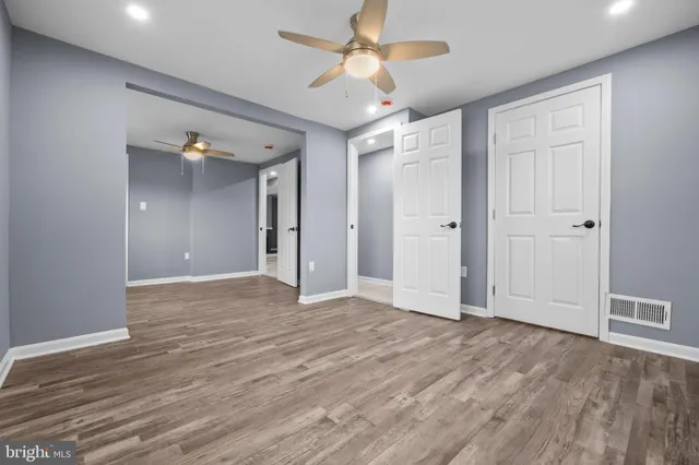 a view of empty room with wooden floor