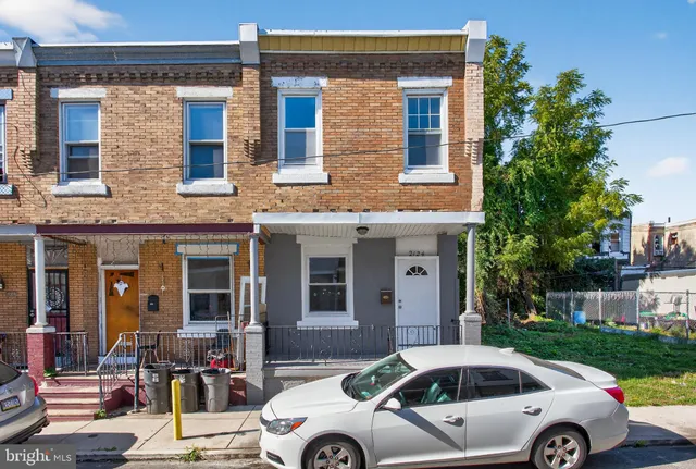 a front view of a house with car parked