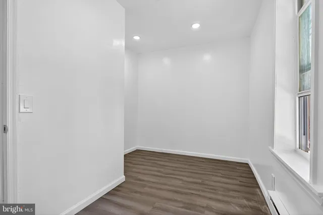 a view of a room with wooden floor