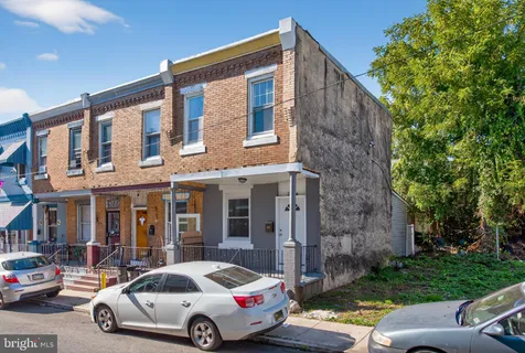 a car parked in front of a brick house